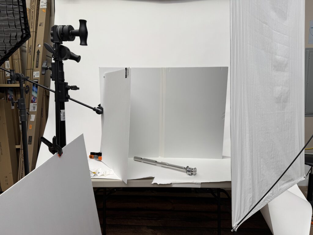 studio-product-photography-workflow-lighting-setup-industrial-product - Brian Mullins | Commercial & Event Photographer Based in Raleigh Studio product photography workflow showing lighting setup, diffusion panels, and bounce cards used to photograph a reflective industrial sensor