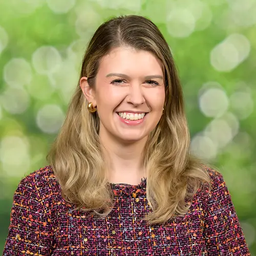 Headshot on studio background at the Duke Fuqua School of Business