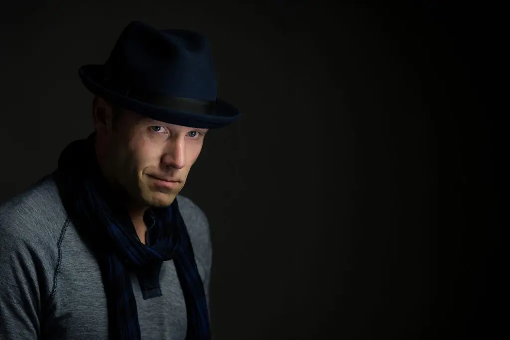 Portrait photographed with dramatic directional studio lighting demonstrating controlled lighting techniques